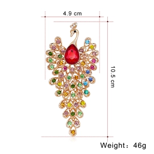 Luxurious large peacock brooch in gold with colorful rhinestones and red teardrop gem
