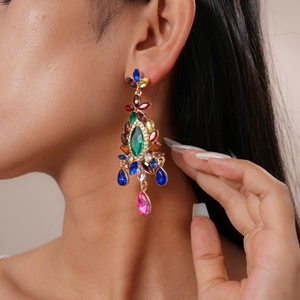 Close-up of bohemian gold earrings with colorful marquise and teardrop crystals