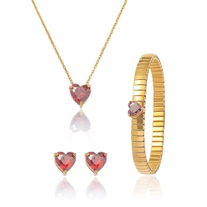 Detailed set of red heart gemstone necklace, stud earrings, and bracelet on white background