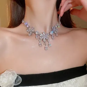 Elegant silver flower necklace set with shimmering teardrop zirconia stones on a model