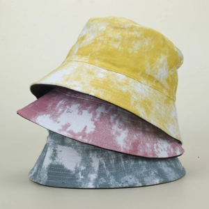 Detailed view of tie-dye bucket hats in yellow, pink and blue with breathable cotton fabric