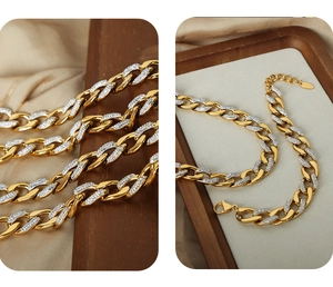 Macro detail of gold and silver steel chain necklace with micro-pave cubic zirconia