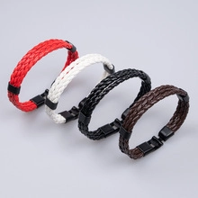 Detail view of woven leather bracelets in red, white, black, and brown with metal clasps