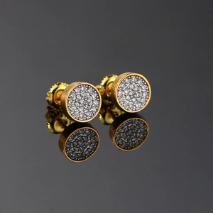 Macro shot of gold hip hop stud earrings with micro paved cubic zirconia and screw backs