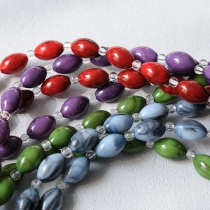 Close-up of colorful resin acrylic beads in olive shape for crossbody bag straps