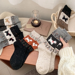 Detailed knit texture of vintage wool socks featuring cute Scottie dog jacquard patterns