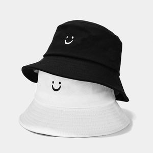 Unisex cotton bucket hat set in black and white with minimalist smile embroidery