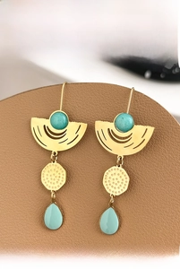 Detail of vintage gold drop earrings with turquoise stone and blue enamel pendants