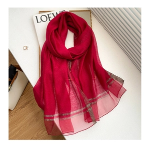 Close-up of wine red silk wool blend scarf with elegant gold metallic stripes