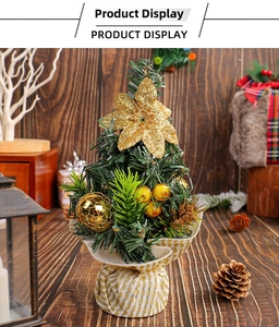 Mini tabletop Christmas tree with gold star, ornaments, and striped fabric base