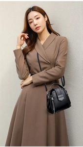 Detail view of black soft leather crossbody bag with detachable strap and metal hardware