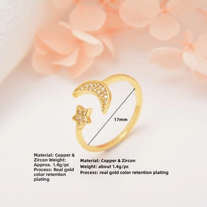 Detail of adjustable star and moon ring in gold plated copper with zircon stones