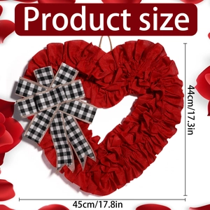 Close-up of red fabric heart wreath with dimensions and black white plaid bow
