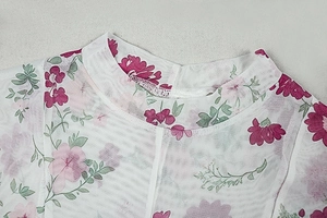 Detail of round neckline on white mesh top with pink floral and green leaf print