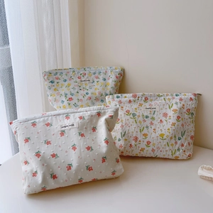 Three-piece floral cotton makeup bag set with zip closure and simple wish logo