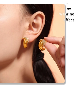Wearing effect of golden crescent moon earrings featuring shimmering micro-pave crystals