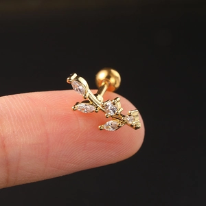 Macro shot of gold branch stud earring with marquise and round white cubic zirconia stones