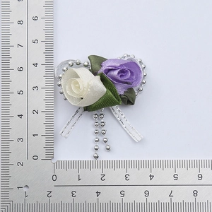 Close-up of handmade purple and white fabric tulip flower brooch with measurement scale