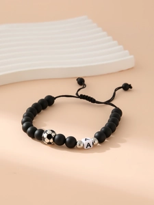Detail of matte black beaded bracelet with silver football bead and letter A charm