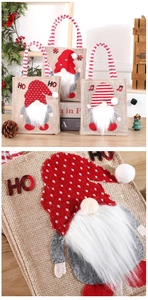 Detailed view of linen Christmas gnome gift bags with plush embroidery and sturdy handles