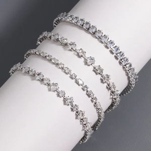 Elegant silver tennis bracelets with varied zircon cuts on white display stand