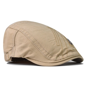 Khaki cotton beret hat with vintage stitching and metal detail from a side profile view