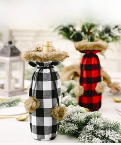 Detail of red and black buffalo plaid wine bottle covers with faux fur trim and pom-poms