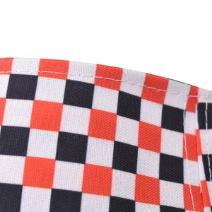 Macro shot of red and black checkered canvas fabric with precise white stitching details