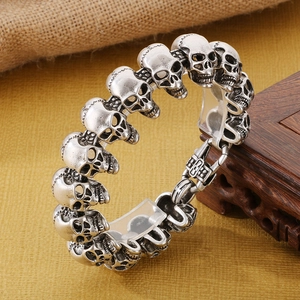 Macro detail of vintage skull head bracelet with distressed silver finish and punk style