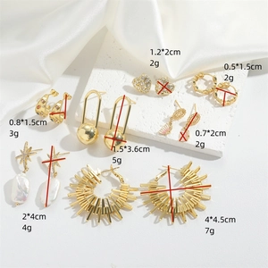 Collection of golden geometric heart and star earrings with pearls and zircon details