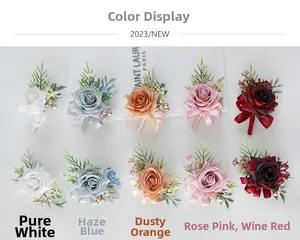 Detailed flat lay of artificial wedding corsages in white, blue, orange, pink and burgundy