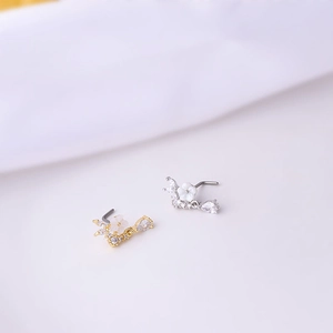 Titanium L-shaped nose studs with white flower charms and sparkling zircons in gold and silver