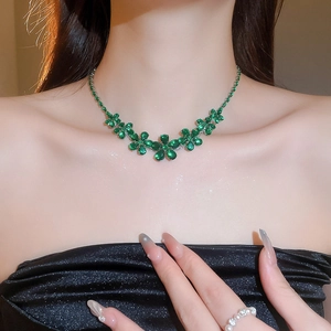 Detailed view of elegant green zircon flower necklace worn on a neck for evening events