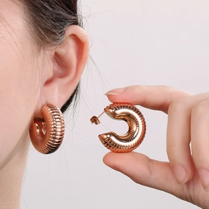 18K gold plated stainless steel C-shaped ribbed earrings shown with size reference