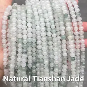 Detailed macro view of natural Tianshan Jade stone beads in light green and white tones
