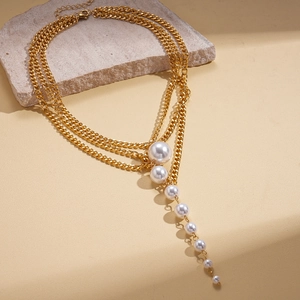 Elegant gold-tone multi-layer necklace featuring a cascading pearl tassel pendant design