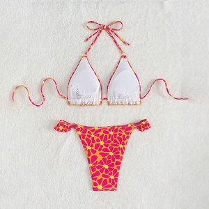 Flat lay of floral bikini with halter neck top and side-tie bottoms on plush rug