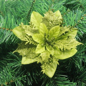 Macro view of green glitter layered fabric poinsettia decoration on Christmas tree