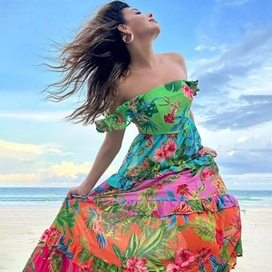 Detail of off-shoulder bohemian beach maxi dress with tropical floral print pattern