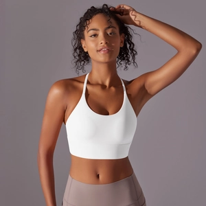 Close-up of white double-sided nylon sports bra with cross back straps and slim fit design