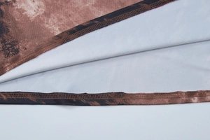 Detail of the double-stitched hem on a leopard print dress with soft white lining fabric