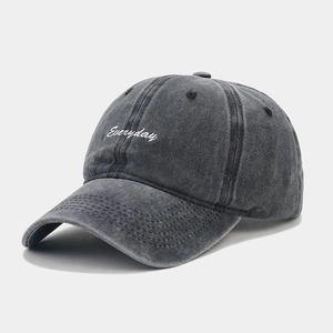Close-up detail of white Everyday embroidery on vintage washed dark grey cotton baseball cap