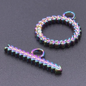 Detailed macro of iridescent rainbow finish toggle clasp with feather scale texture