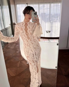 Dettaglio vestito in pizzo bianco con scollo alto intrecciato e maniche a campana
