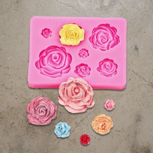 Pink silicone mold featuring 7 varied rose sizes for DIY fondant or resin casting crafts