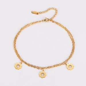 Detail of double-layer gold stainless steel anklet featuring three flower pendants and lobster clasp