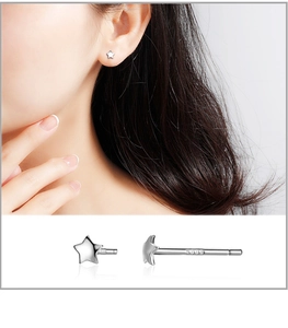 Macro detail of S999 sterling silver star stud earring showing the metal hallmark stamp