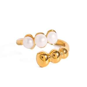 Minimalist gold open ring featuring white pearls and golden beads on a white background