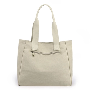 Minimalist beige canvas tote bag featuring large capacity and a functional rear zipper pocket