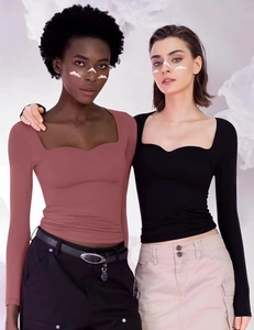 Detail view of square neck long sleeve crop tops in brick red and black colors